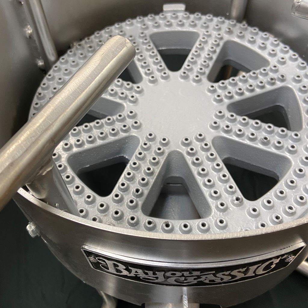 Close-up of a cast iron banjo burner in a stainless cooker