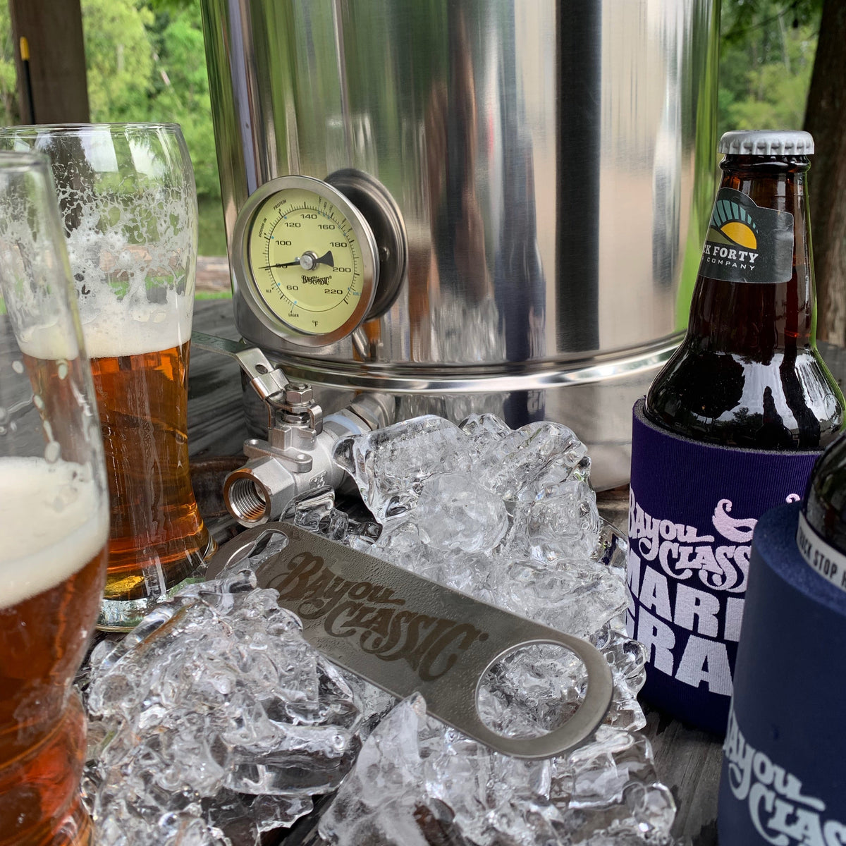 Stainless Bar Blade sitting in ice surrounded by glasses of beer, a bottle of beer, and a brew kettle