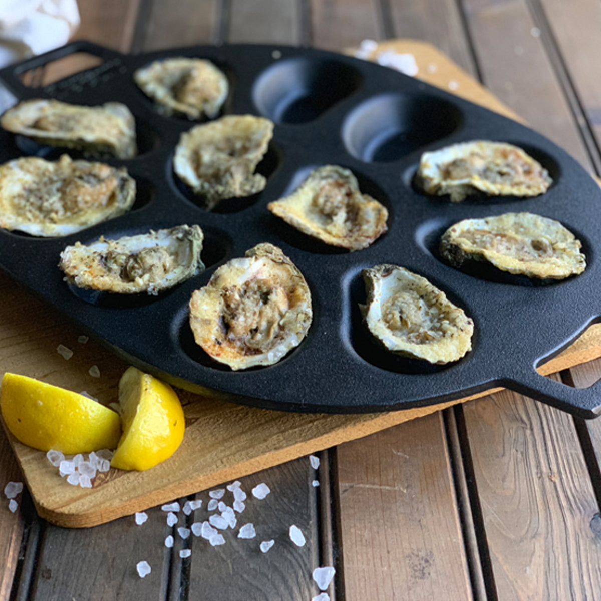 Chargrilled oysters in a cast iron oyster grill pan 